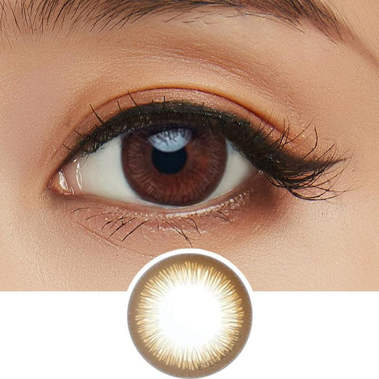 Close-up shot of model's eye adorned with Acuvue 1-Day Define Radiant Brown color contact lens dailies, complemented by clean eye makeup, showing the brightening effect of the circle lenses on dark brown eyes, above a cutout of the colour contact lens design with radial spiked pattern